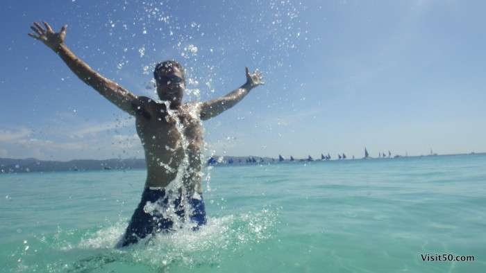 Jumping fun in the crystal clear waters of Boracay island while Island hopping in the Philippines